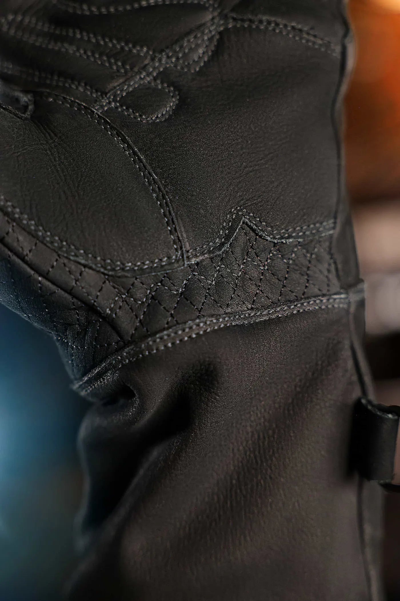 Close-up of black-thread leather work gloves showing diamond-pattern stitching and fine leather texture, highlighting craftsmanship and durability Rated 4.70 – Black
