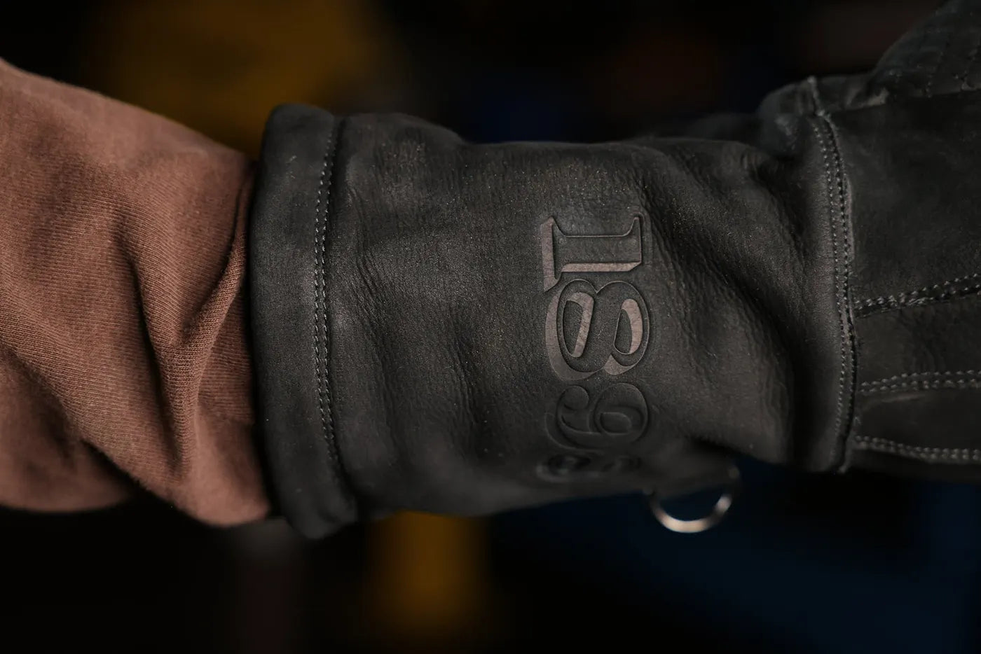 Close up of black-thread leather work glove with “1898” logo embossing and visible stitching, highlighting premium leather texture and craftsmanship – Rated 4.70 – Black