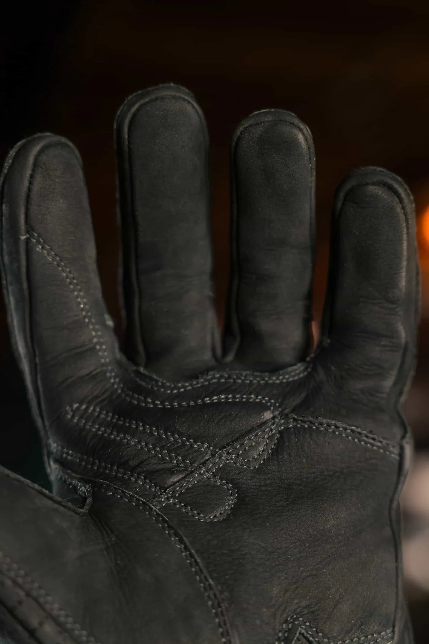 Close up of black thread leather work glove showing reinforced stitching across palm and fingers, highlighting durability, grip, and artisan craftsmanship – Rated 4.70 – Black