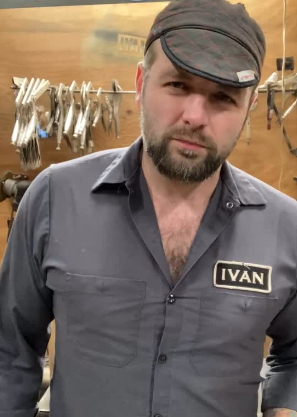 Metal sculptor Ivan Iler in his workshop wearing a work shirt with IVAN name patch