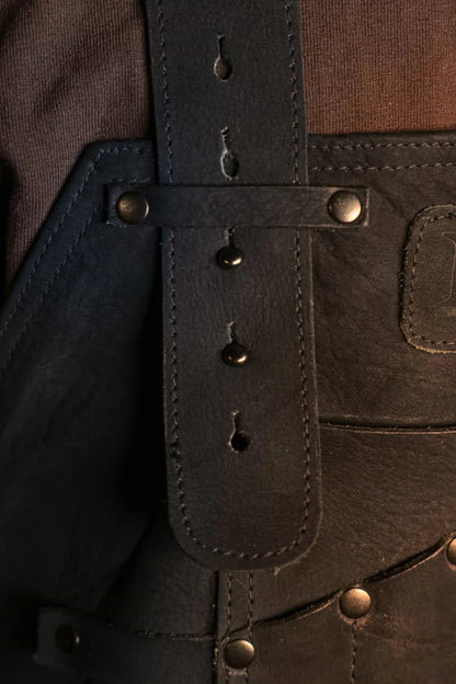 Close-up of 1898 Leather welding apron strap and button with black thread — detailed view highlighting craftsmanship and durability, rated 4.85 stars - Black