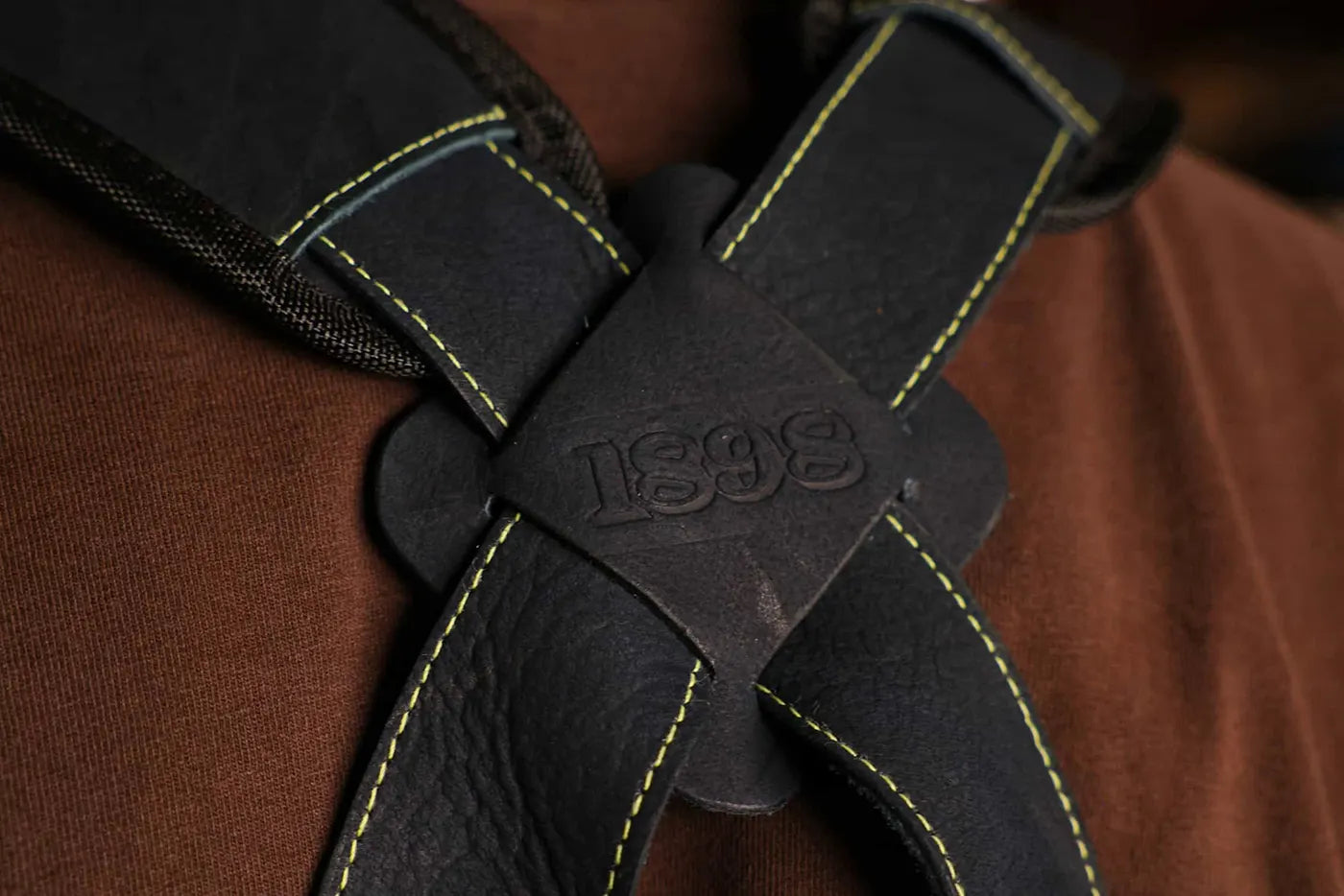 Back view of 1898 Leather welding apron gold thread with shoulder crossover straps forming an X and 1898 logo at the intersection premium quality apron rated 4.85 stars - Gold