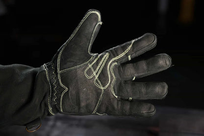 Close-up of leather glove with light-colored stitching on the palm and fingers, worn on a hand with fingers spread, highlighting contrast stitching, craftsmanship, and durability Rated 4.70 – Gold